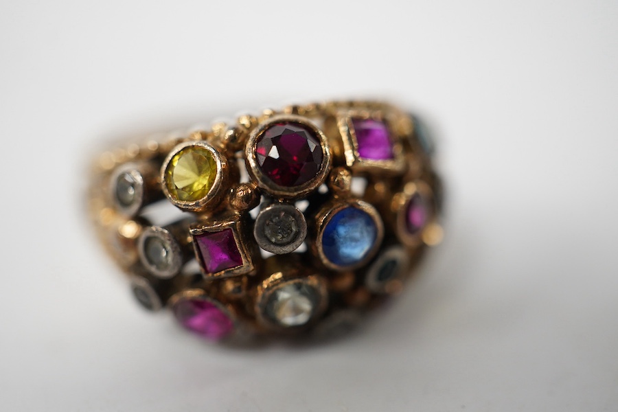 A 1940's continental yellow metal and multi gem set cluster dress ring, size P, gross weight 6.6 grams. Condition - poor to fair